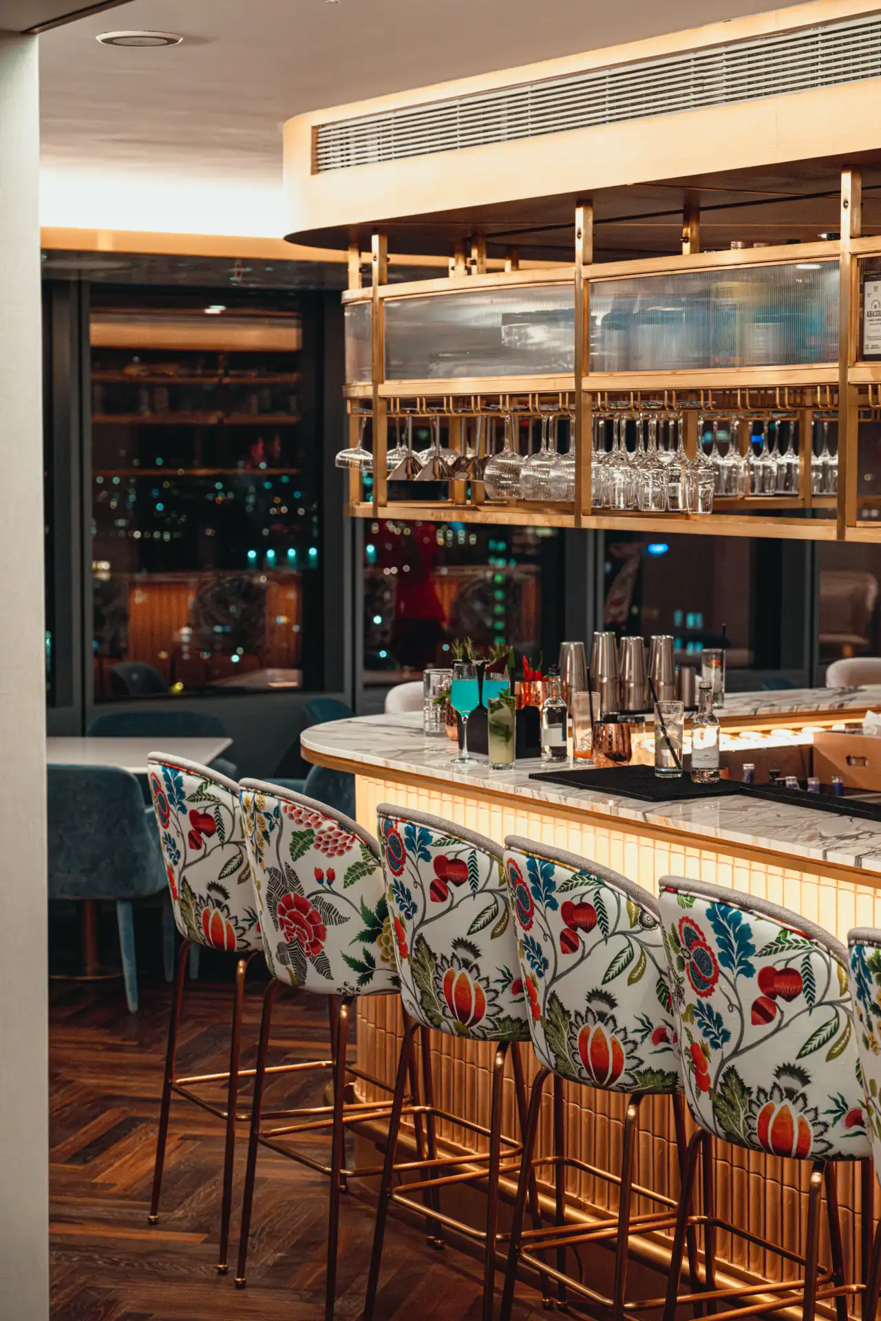 Qibo Skybar interior featuring the signature floral bar stools and marble bar